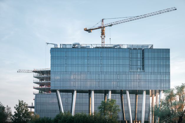 A building with a glass facade which is held on metal columns