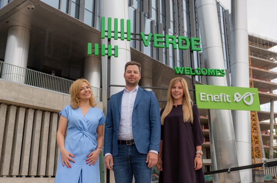 Image of three people standing in front of an office building