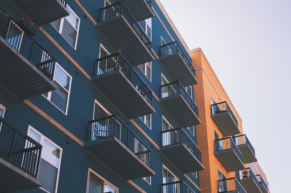 A corner of a building of blue and orange color